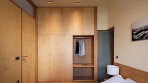 A bedroom with a bed, a wardrobe, a hanging rack, and a lamp. - Ismini House (Chania)