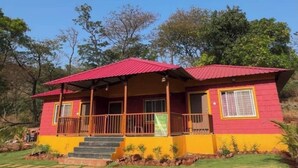 A two-story house with a red roof, yellow walls, and a porch with railings. - Mountain View Villa - Mulshi (Paud)