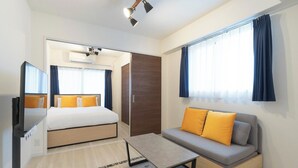 A hotel room with a bed, a sofa, a small table, a mirror, and a wardrobe. - Curasion Oyodonaka (Osaka)