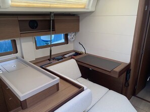 A compact, well-organized interior with a bed, a small desk, and a window. - Sun-Kissed Sailing Adventure in the Ionian Islands, Lefkada (Lefkada)