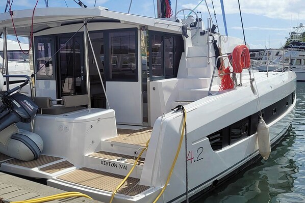 Un yate con cubierta blanca, camarote con ventanas y el número '4.2' en el costado.