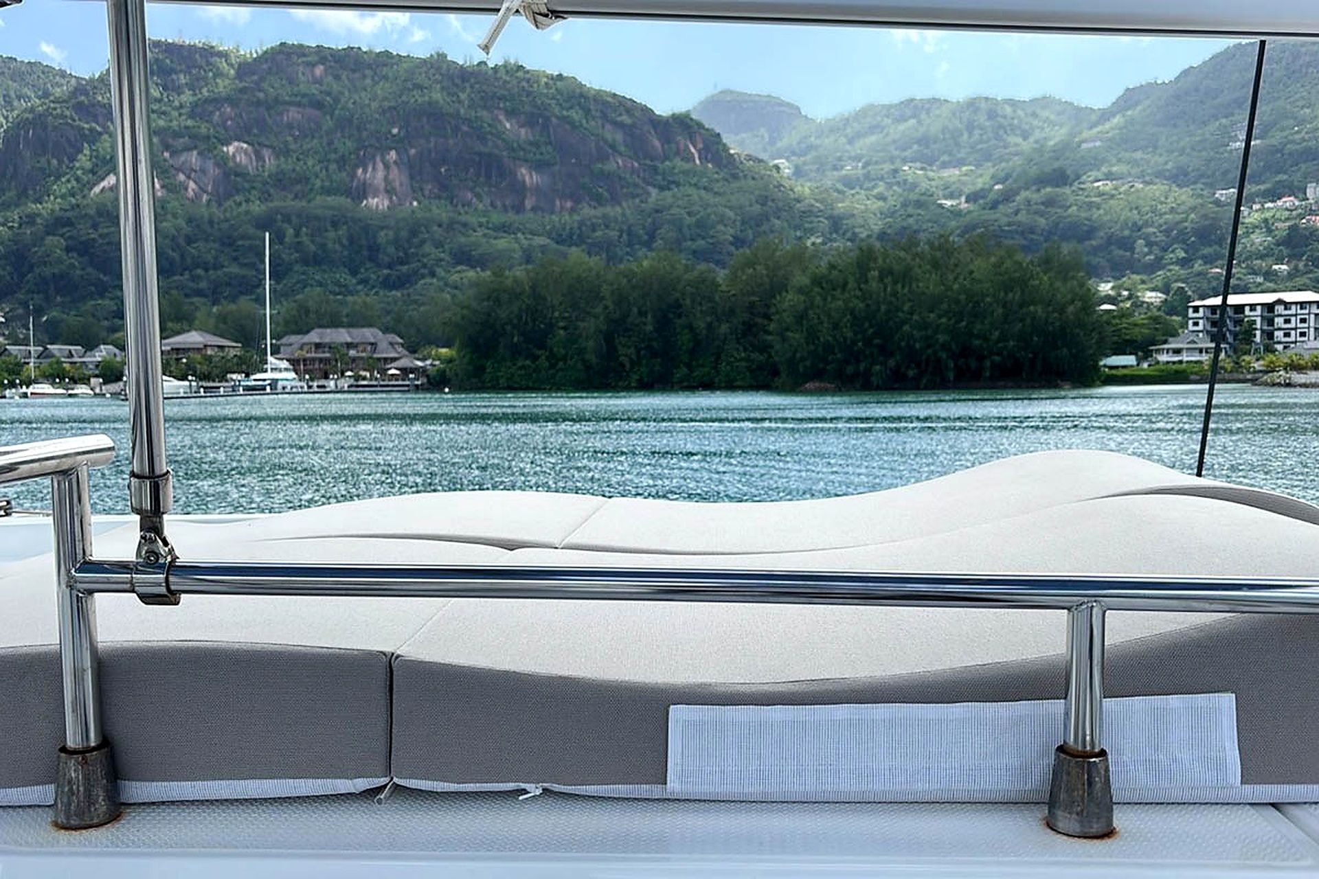 A boat with a view of a lake and mountains in the background.