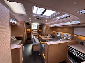A compact, well-lit interior with a kitchenette, seating area, and a small dining space.