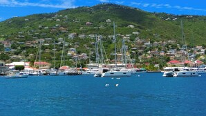 A marina with boats docked, a hillside with buildings, and clear blue skies. - Sun-Kissed Sailing: A Caribbean Beach Experience from Islas Vírgenes de Estados Unidos, Santo Tomás (St Thomas)