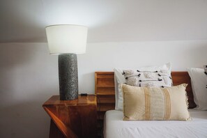A bed with white bedding, a wooden nightstand, a lamp with a textured base, and a power cord plugged in. - Zezere Single Bedroom, Hostel Idanha, Idanha-a-Nova (Idanha-a-Nova)