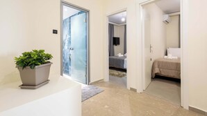 Ein Hotelzimmer mit Bett, Fernseher und einem Badezimmer mit Dusche.