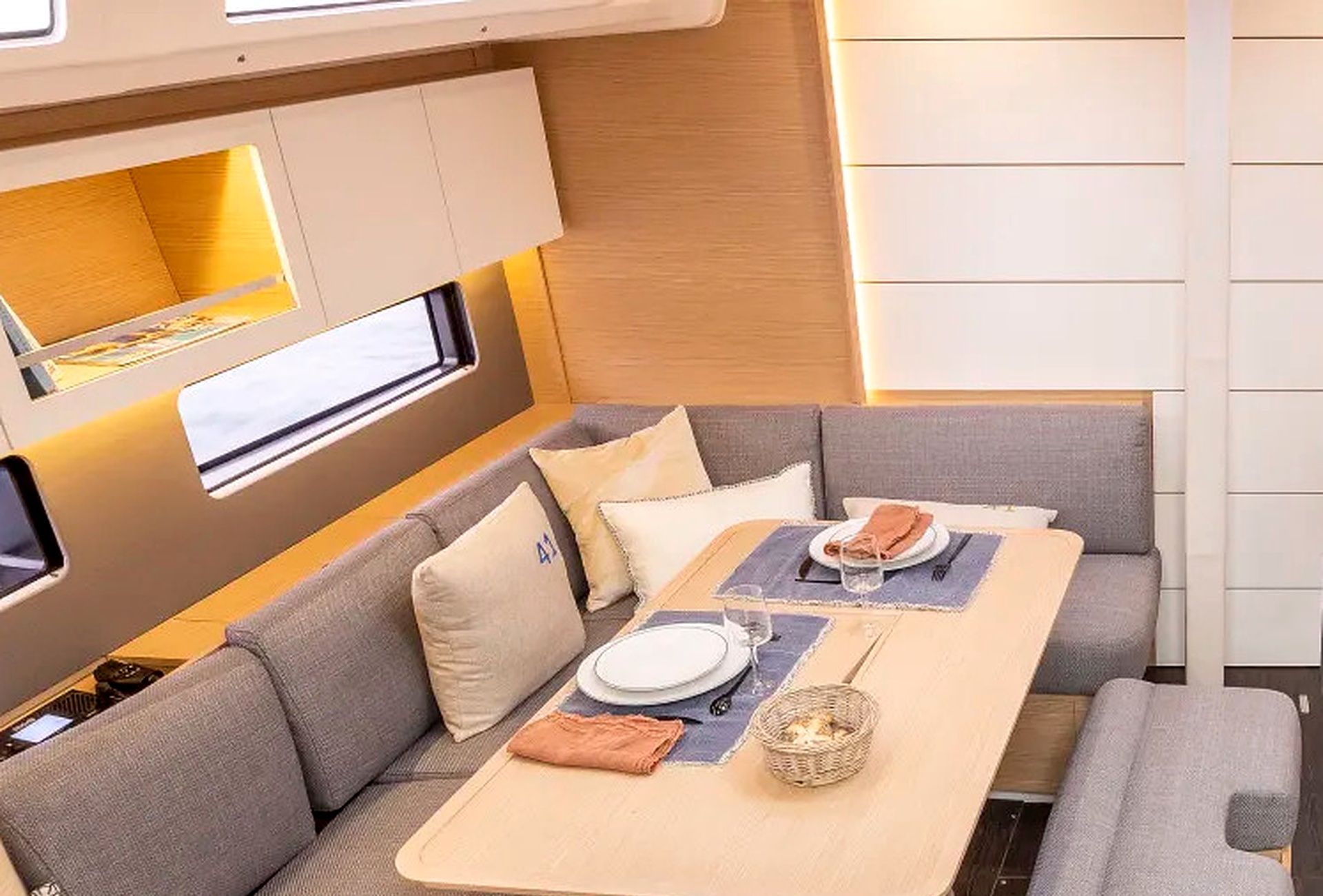 A compact dining area with a table set for two, cushioned seating, and a window for natural light.