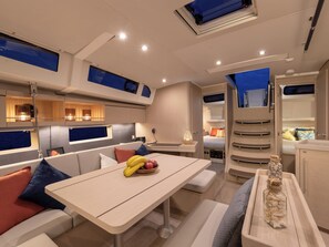 A modern interior with a dining area, seating, and a kitchen. - Caribbean Dream: Sun-soaked Sailing Adventure from Tortola, Islas Vírgenes Británicas (Road Town)