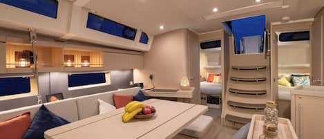 A modern interior with a dining area, seating, and a kitchen.