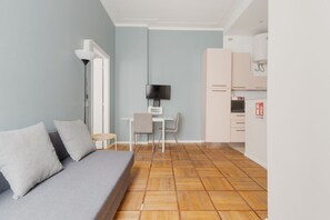 A modern living room with a sofa, a TV, a small table, and a chair. - Elegant flat of 60m2, perfect for 4 people, located on the first floor with lift.The accommodation is in Missori, in the heart of Milan’s historic center, a few steps from the Duomo, near Velasca Tower and Palazzo del Novecento.Well-connected area (M3  (Milan)
