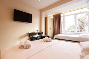 A hotel room with two beds, a desk, a flat-screen TV, and a window with curtains. - Grandstay Tirana Central (Tirana)