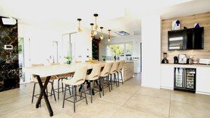 A modern kitchen with a built-in oven, a coffee machine, and a refrigerator. - Villa Les Oiseaux Du Paradis Cavalaire-sur-mer (Cavalaire-sur-Mer)