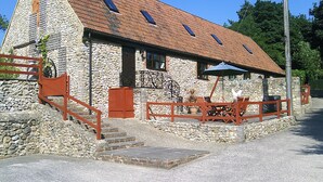 A stone building with a sloped roof, a staircase, and outdoor seating. - Cider Cottage - Near Lyme Regis (Axminster)