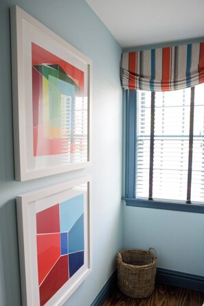 A room with two framed abstract artworks, a window with striped valance, and a wicker basket. - Marion HOUSE - Village, Large Deck, Close to Tabor (Marion)