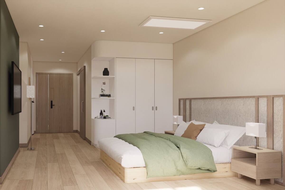 Ein modernes Schlafzimmer mit Bett, Nachttischen, einem Kleiderschrank und einem Fernseher.