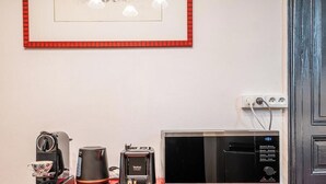 Ett litet kök med kaffebryggare, brödrost och mikrovågsugn.