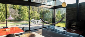 Luxury house in the mountains surrounded by nature and rock cliffs.