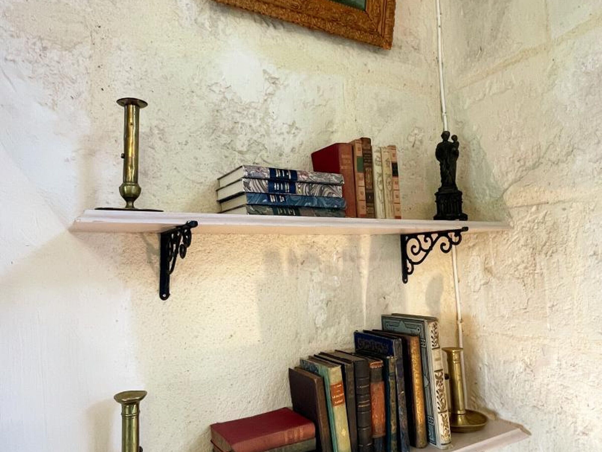 A bookshelf with books and decorative items.