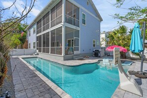 A two-story house with a swimming pool, a balcony, and a patio area. - The Salty Palm l Pool l Walk to DNTN (St. Augustine)