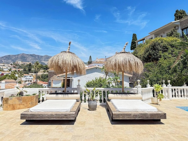 A rooftop terrace with two beds, a pool, and a view of the city and mountains. - Seaview Villa in Fuengirola, Pool, Sleeps 16 (Fuengirola)
