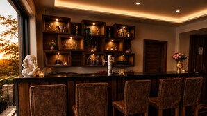 A bar area with wooden shelves, bar stools, and a statue. - Zenith Hotel Frankfurt Airport  (Kelsterbach)
