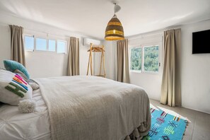 A bedroom with a large bed, a hanging light fixture, a wooden ladder, and a view of greenery outside. - Luxury spacious detached villa with private pool, large terrace and 7 bedrooms! (Gata de Gorgos)