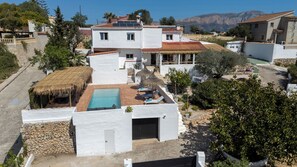 A modern villa with a swimming pool, outdoor seating, and a view of the mountains. - Luxury spacious detached villa with private pool, large terrace and 7 bedrooms! (Gata de Gorgos)