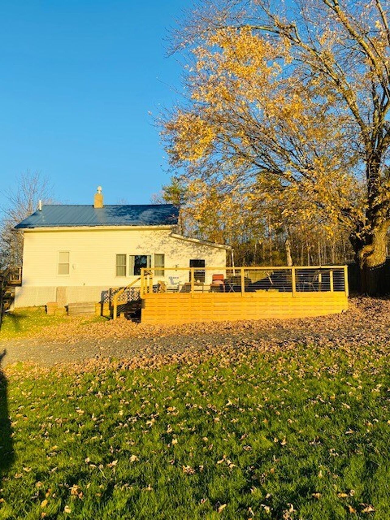 A single-story building with a flat roof, a front porch, and a small staircase leading to the entrance.