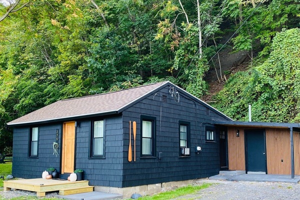 Moody in black with a cedar door, we love how it tucks itself away amongst the trees.