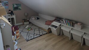 A compact room with a sloped ceiling, a bed, a desk, a bookshelf, and a skylight. - House between Nantes and Pornic (Sainte-Pazanne)