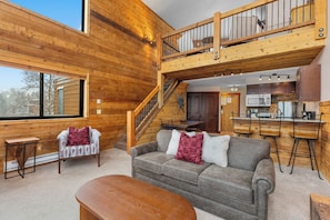 A wooden cabin interior with a living area, a staircase, and a kitchen. - Lake-View Condo - 5 Min Drive to Keystone Ski Village (Keystone)
