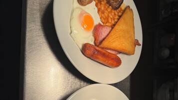 Two plates of breakfast food on a table.