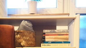 A bookshelf with books and a PS4 console. - High standard + private cinema & PS4 + close to Old Town (Warszawa)