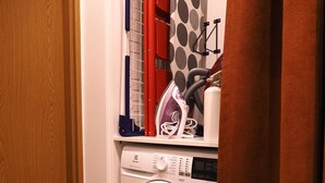 A laundry area with a washing machine, a drying rack, and a curtain. - High standard + private cinema & PS4 + close to Old Town (Warszawa)