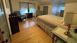 A bedroom with a bed, a desk, a chair, a dresser, and a window. - Classic NH Lake House | Sandy Beach, 2 Boat Dock, Sleeps 10 (Mirror Lake)