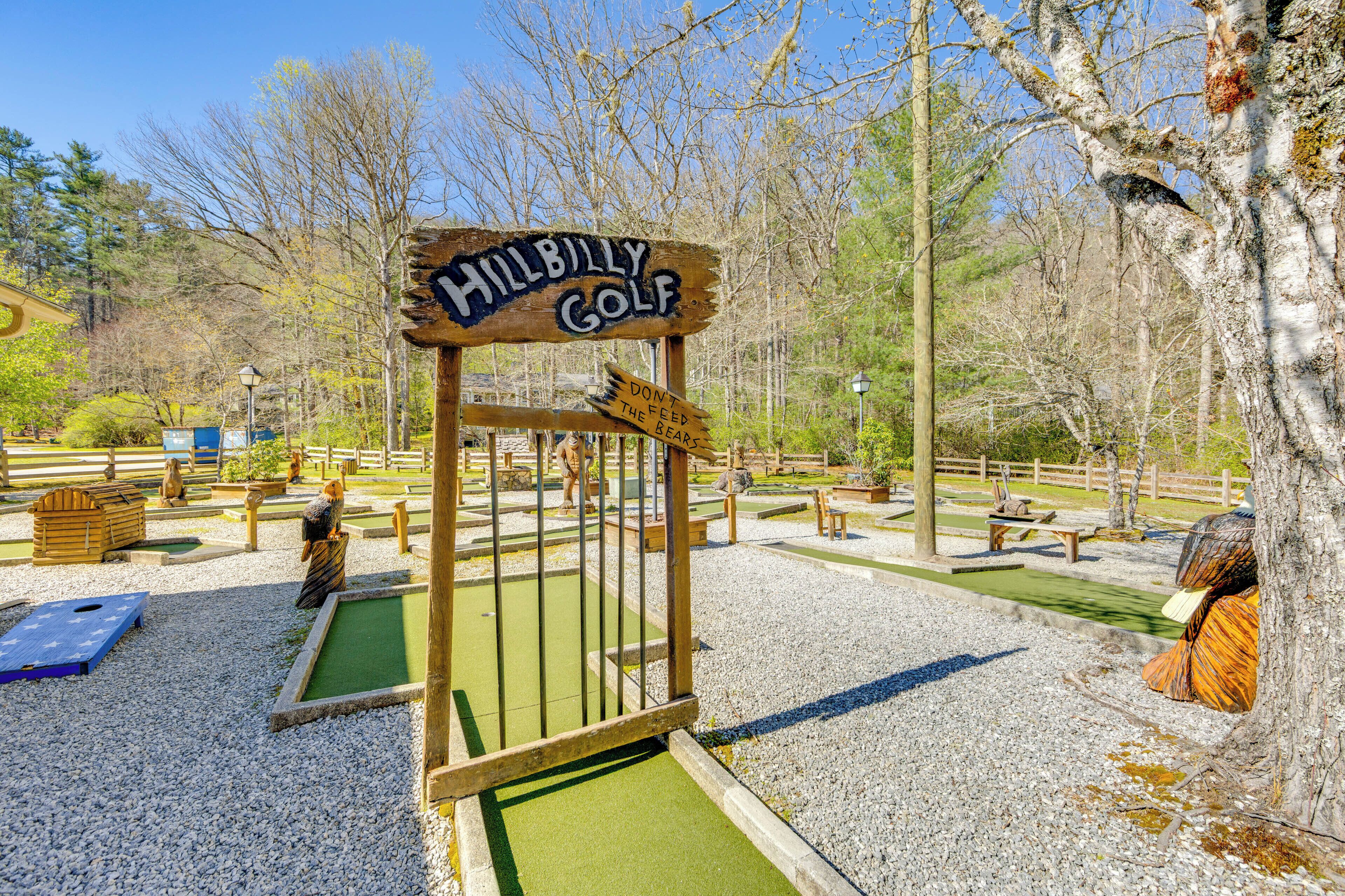 A miniature golf course with a wooden sign that reads 'HillBilly Golf.'