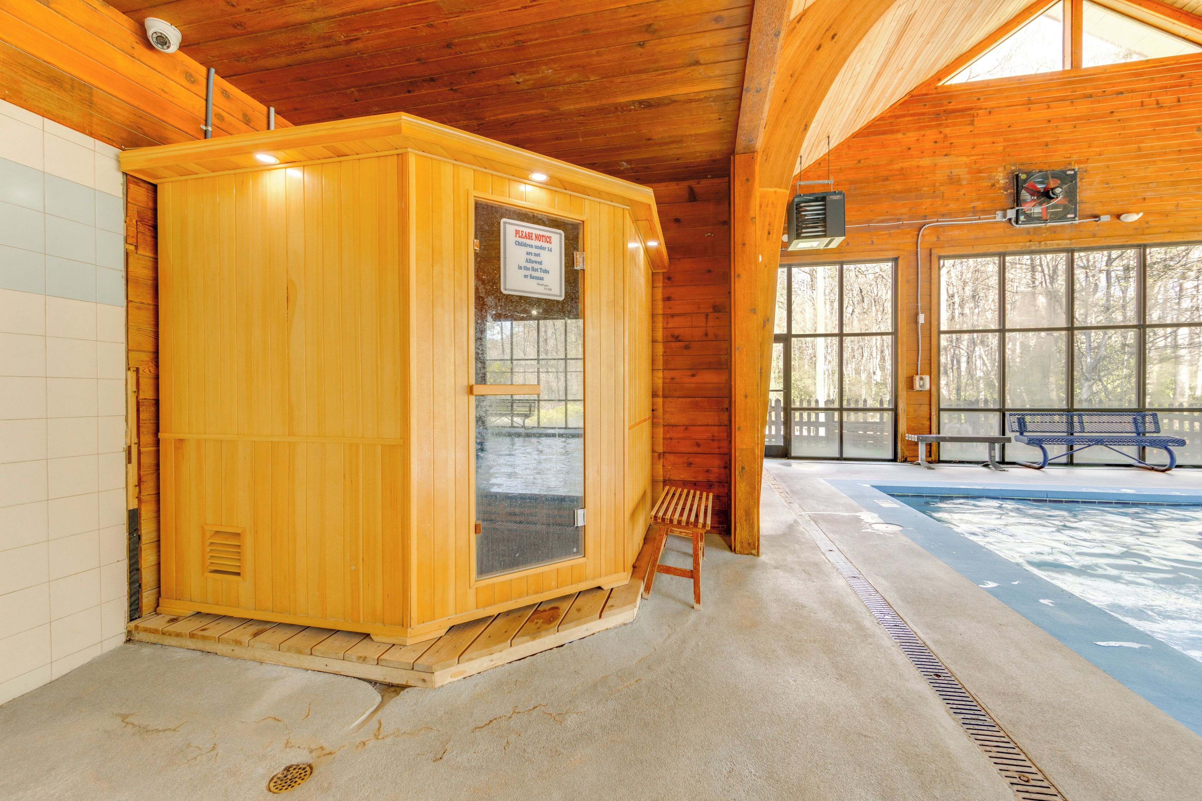 Un sauna avec une structure extérieure en bois, un banc et une fenêtre.
