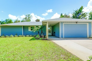 A single-story house with a garage, a covered porch, and a well-maintained lawn. - Private Yard, Lanai! Pet-friendly Fort Pierce Home (Fort Pierce)