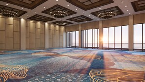 A spacious room with a patterned carpet, large windows, and a high ceiling with recessed lighting. - Mövenpick Resort Carita (Carita)