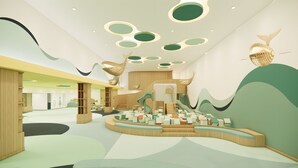 A modern interior with a central play area, wooden structures, and abstract wall designs. - Mövenpick Resort Carita (Carita)