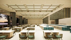 A spacious indoor dining area with high ceilings, large windows, and a central bar area. - Mövenpick Resort Carita (Carita)