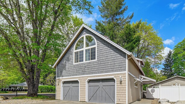 A two-story house with a garage, a large tree, and a clear sky. - Patio & Game Room! Cozy Studio Near Oregon Caves (Cave Junction)