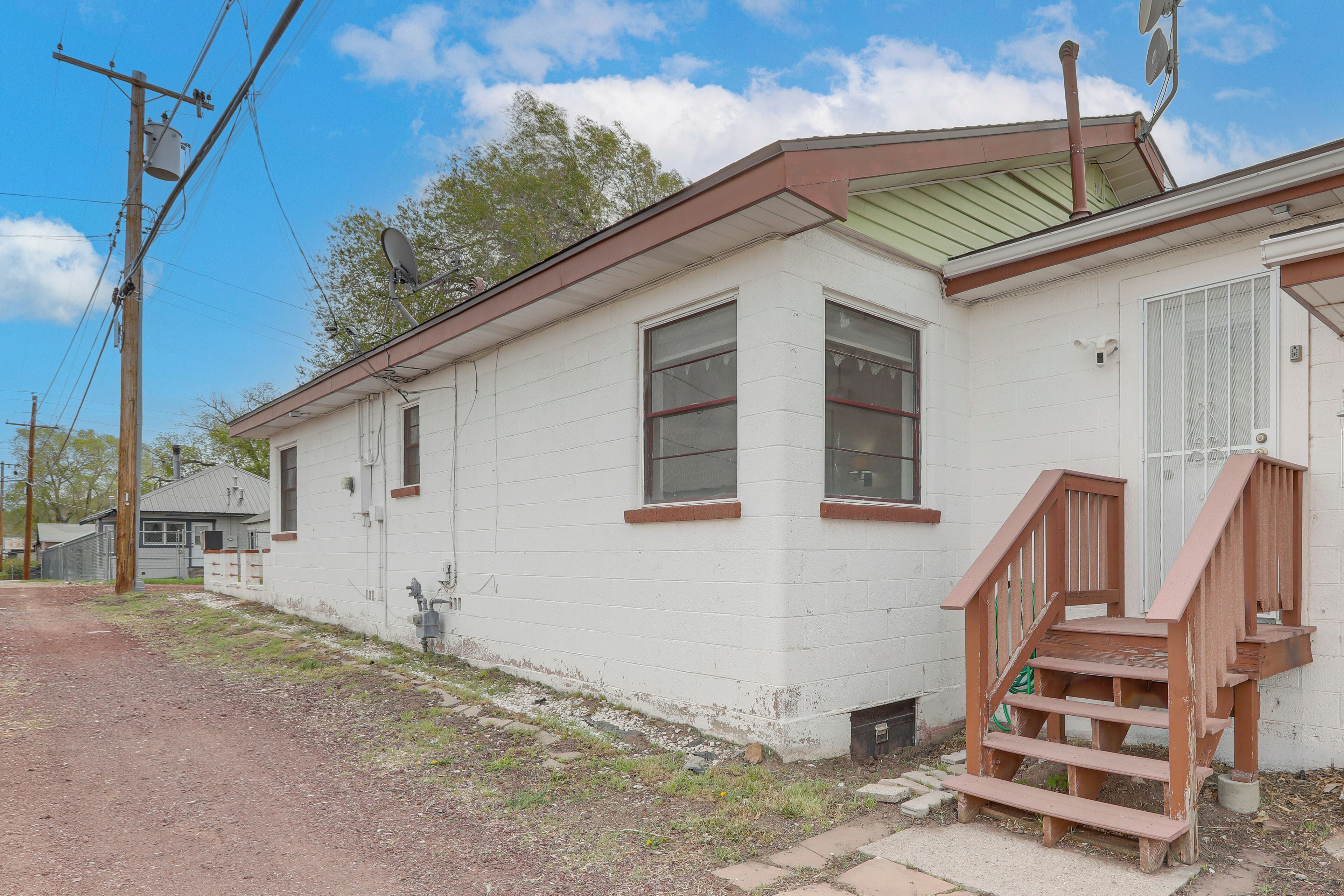 A single-story building with a front porch and a staircase leading to the entrance.