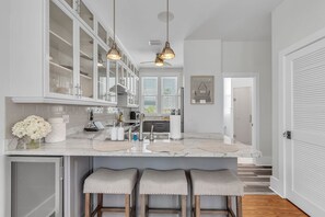 A modern kitchen with white cabinetry, a marble countertop, and pendant lighting. - 🏠Single Family Home🐶Dog OK🐬Quick/Easy Walk to Beach🌴Casa Solmar (Treasure Island)