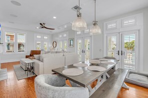 A modern kitchen with a wooden table, pendant lights, and a built-in oven. - 🏠Single Family Home🐶Dog OK🐬Quick/Easy Walk to Beach🌴Casa Solmar (Treasure Island)