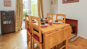 A dining area with a wooden table, chairs, and a cabinet. - Highbury (Bath)