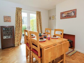 A dining area with a wooden table, chairs, and a cabinet. - Highbury (Bath)