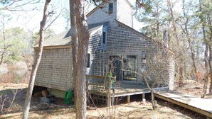 A house with a sloped roof, a front porch, and a small deck. - Iconic 70s style cute condo cottage in Deck 2, on a pond! (CS0055) (Wellfleet)