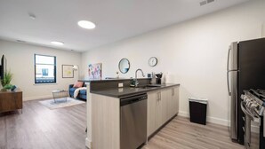 A modern kitchen with a dishwasher, sink, and a stainless steel refrigerator. - Peaceful ! Free Parking ! 30 min to MetLife ! (City of Orange)