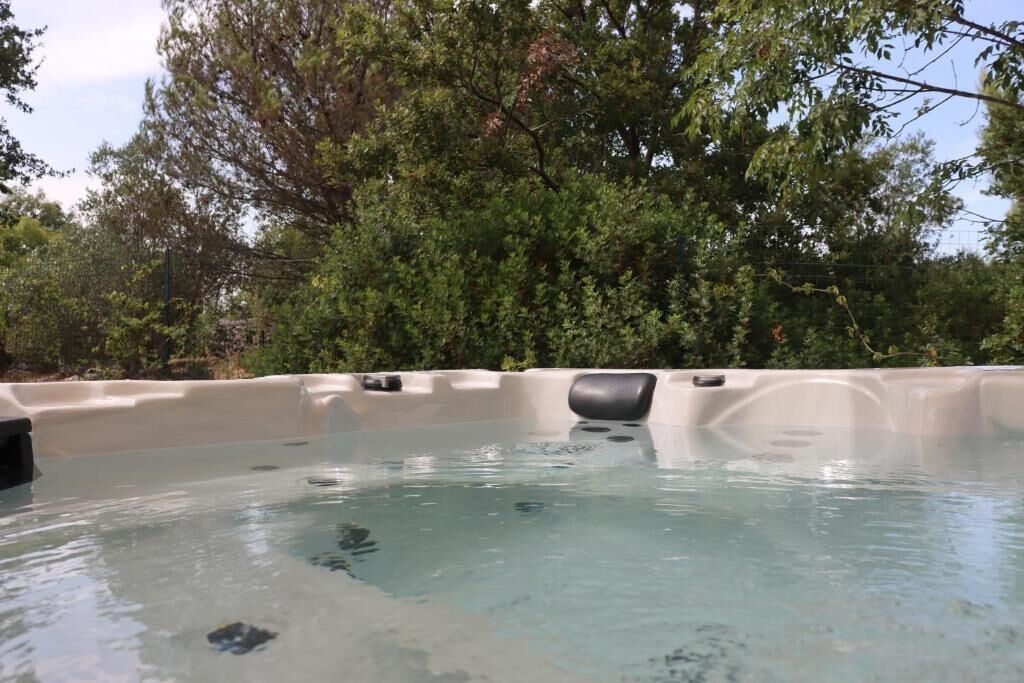 A hot tub surrounded by trees.